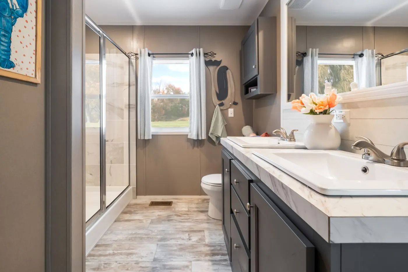The THE DRIFTWOOD Primary Bathroom. This Manufactured Mobile Home features 3 bedrooms and 2 baths.