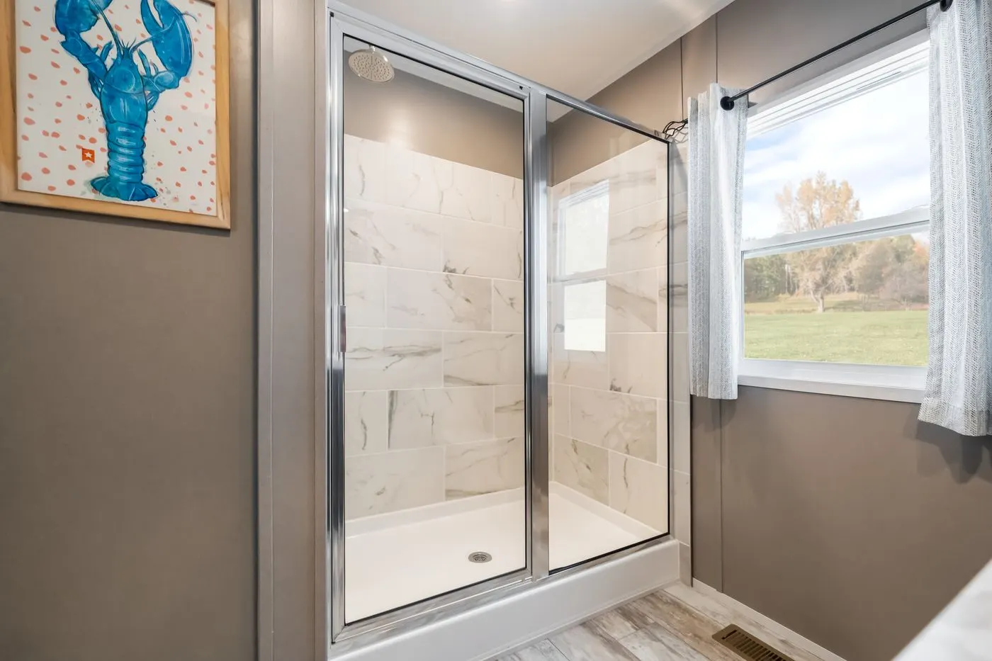 The THE DRIFTWOOD Primary Bathroom. This Manufactured Mobile Home features 3 bedrooms and 2 baths.